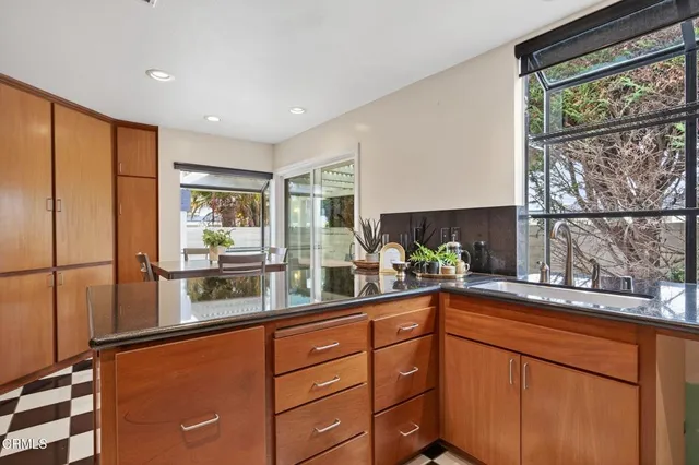 a kitchen with stainless steel appliances granite countertop a stove and a white cabinets