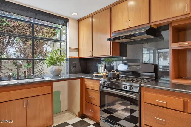a kitchen with stainless steel appliances a refrigerator and cabinets