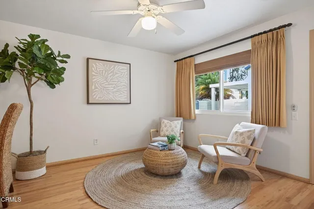 a living room with furniture a potted plant and a fireplace