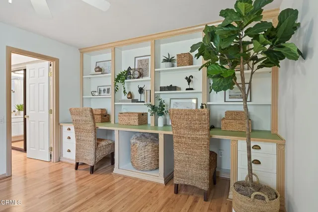 a spacious bedroom with a bed and a dresser