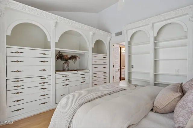 a bedroom with a large bed and a chandelier