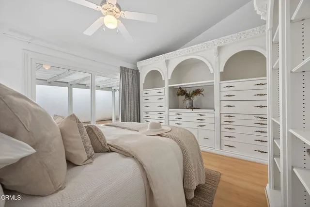 a bedroom with bed and a chandelier