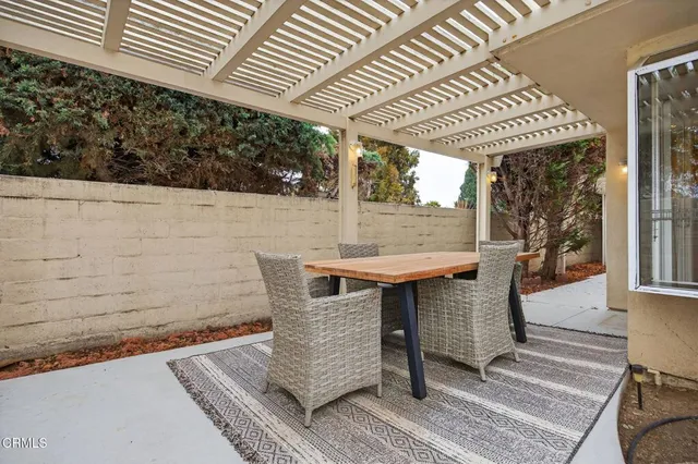 a view of backyard with swimming pool and seating space