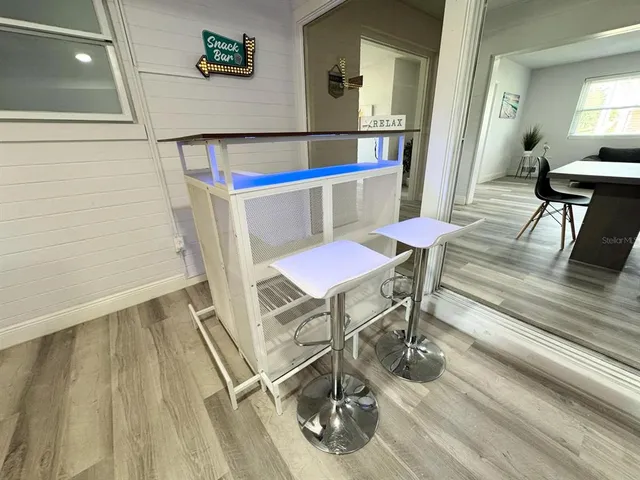 a view of a dining room with furniture and wooden floor