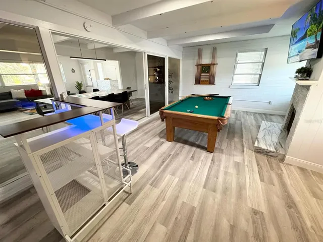 a room with wooden floor and furniture