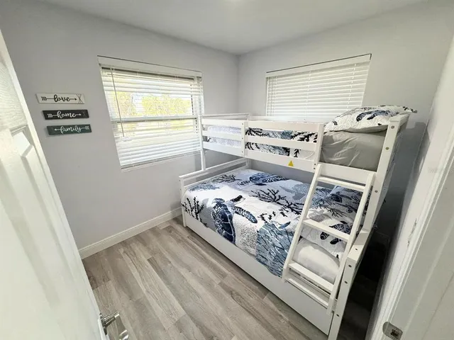 a bedroom with a bed next to a window