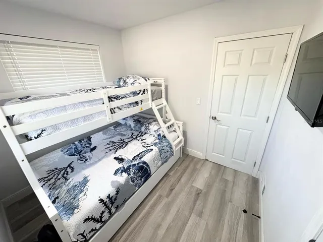 a bed sitting in a bedroom next to a window