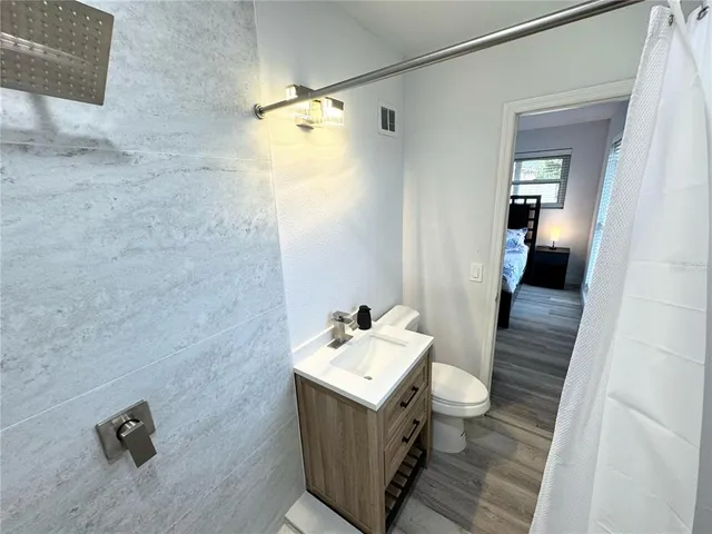 a bathroom with a sink mirror and toilet