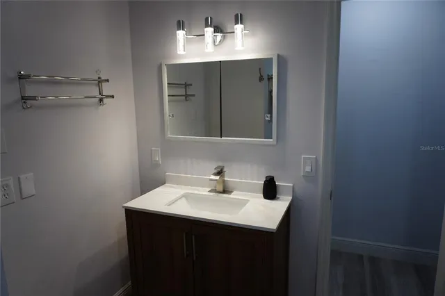 a bathroom with a sink and a mirror