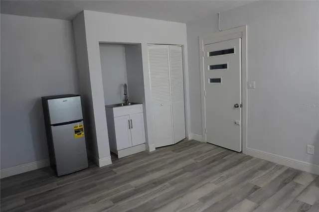 an entryway at a hallway with wooden floor