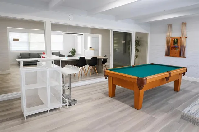 a living room with furniture a table and a large window