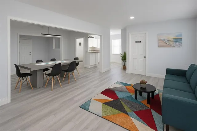 a living room with furniture a rug and a window