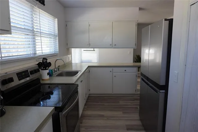 a kitchen with a sink stove and refrigerator