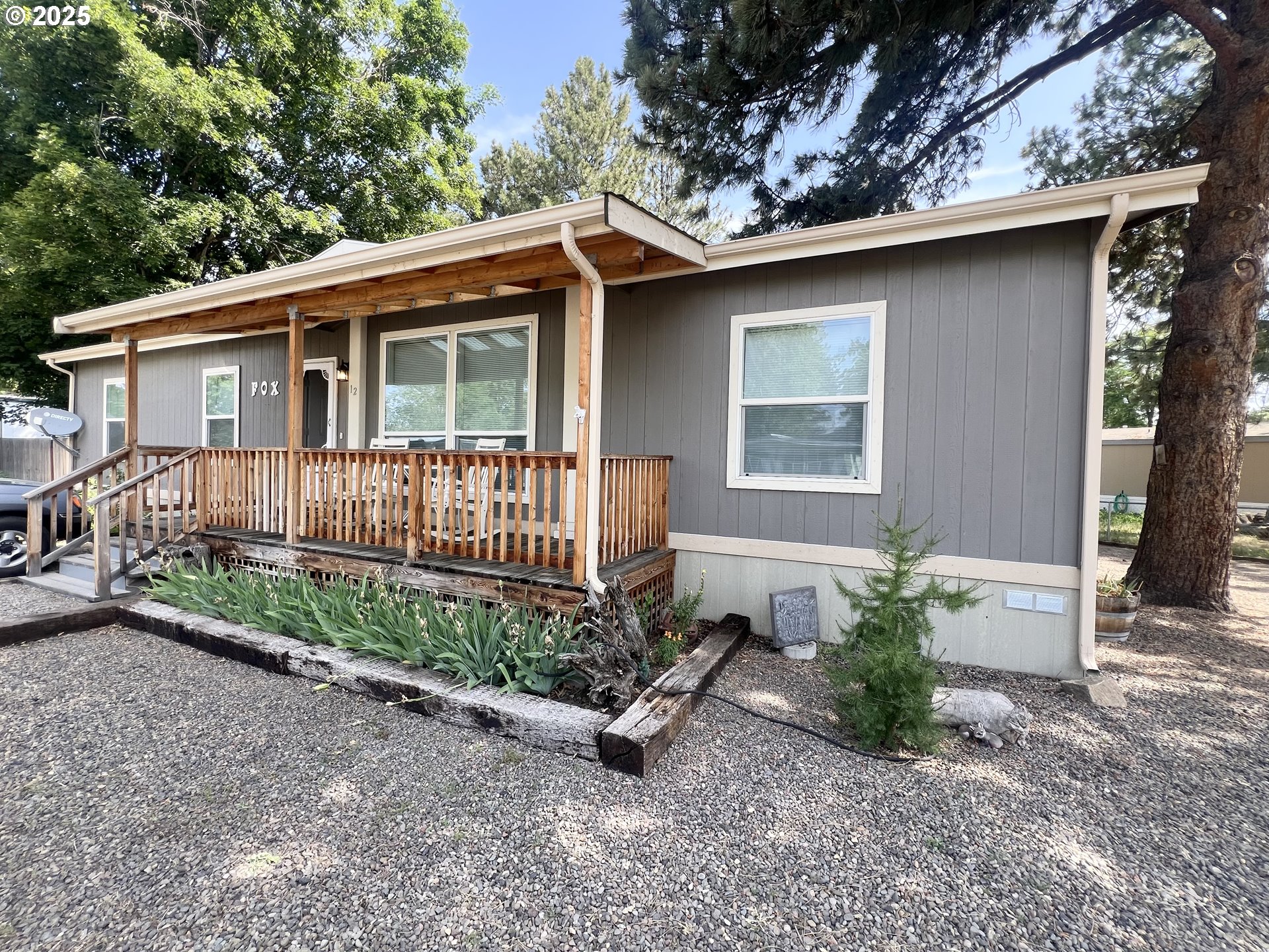 1809 26th Street, Unit 12 La Grande, OR 97850 - Photo 1 of 16 a front view of a house with garden