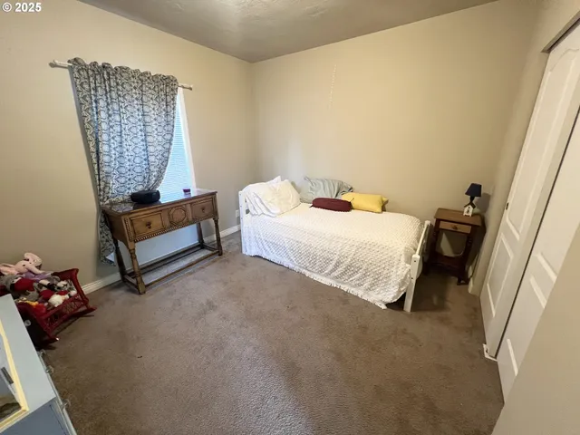 a bedroom with a bed and a couch