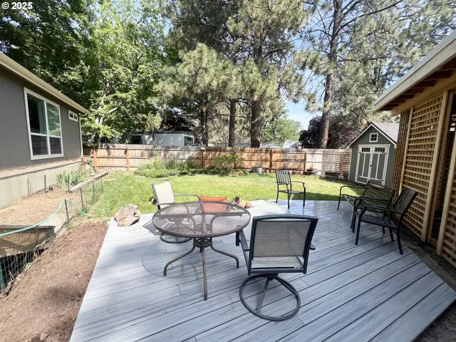 a view of a chairs and table in the patio with a fire pit