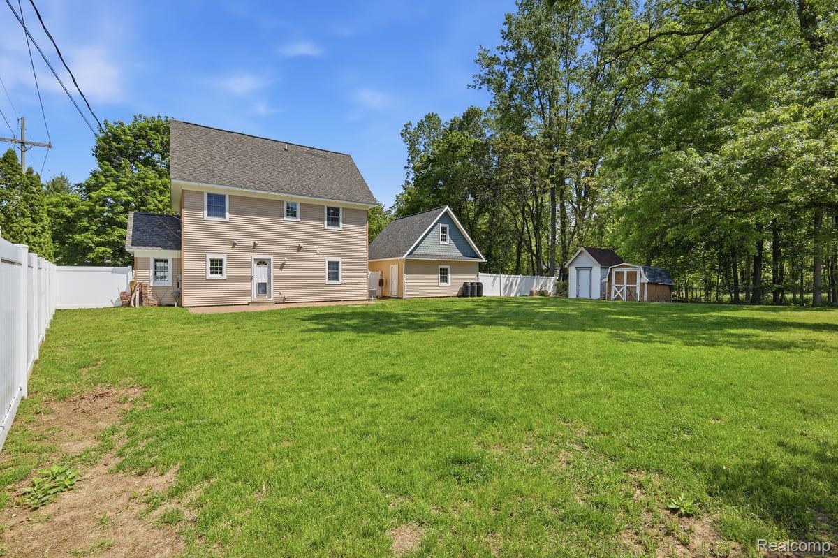 5685 Crescent Road Waterford, MI 48327 - Photo 34 of 47 Expansive green lawn bordering a white privacy fence
