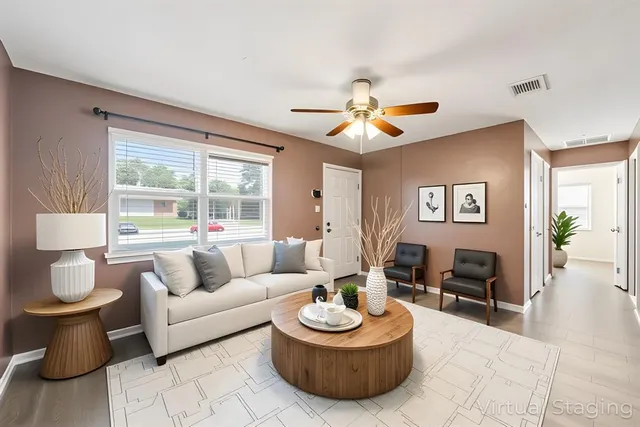 a living room with furniture and a large window