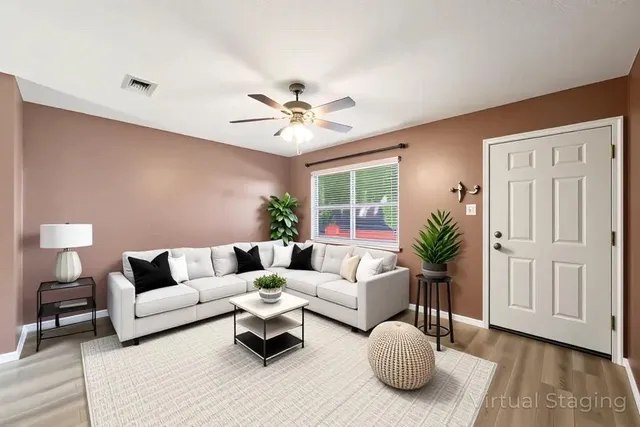 a living room with furniture and wooden floor