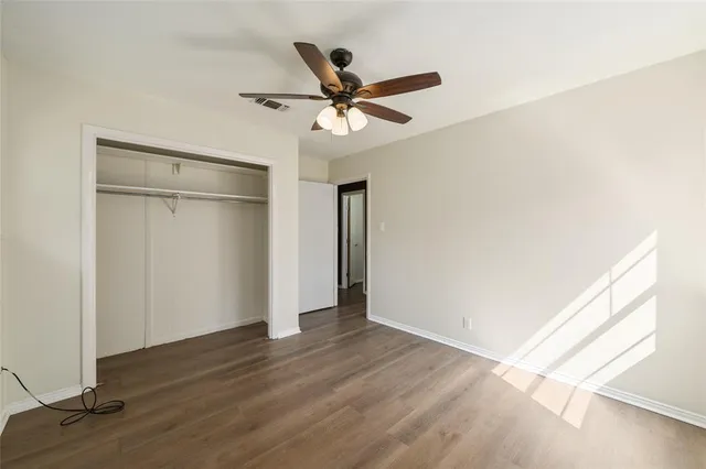 a view of a ceiling fan and wooden floor