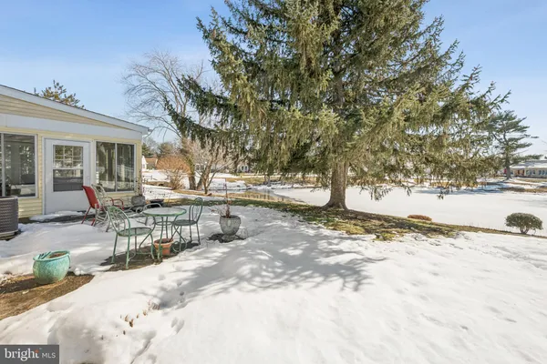 a view of a house with a snow in a yard