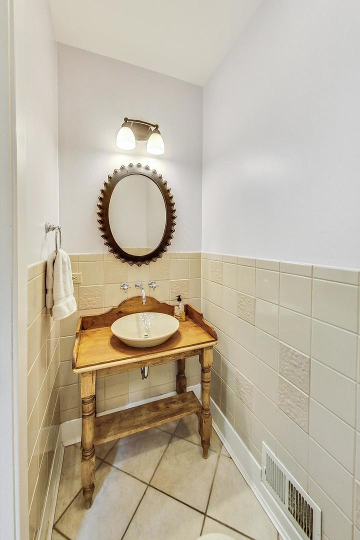 929 Valley Road Glencoe, IL 60022 - Photo 16 of 46 a bathroom with a sink mirror and toilet