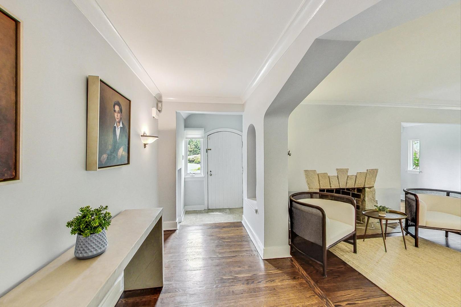 929 Valley Road Glencoe, IL 60022 - Photo 2 of 46 a view of a hallway to a livingroom and couch