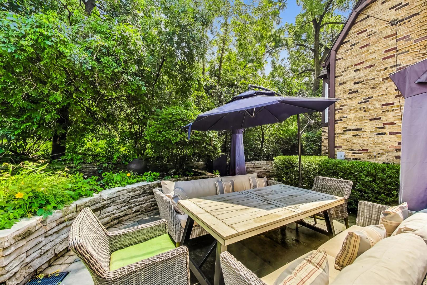 929 Valley Road Glencoe, IL 60022 - Photo 40 of 46 an outdoor space with furniture and umbrella