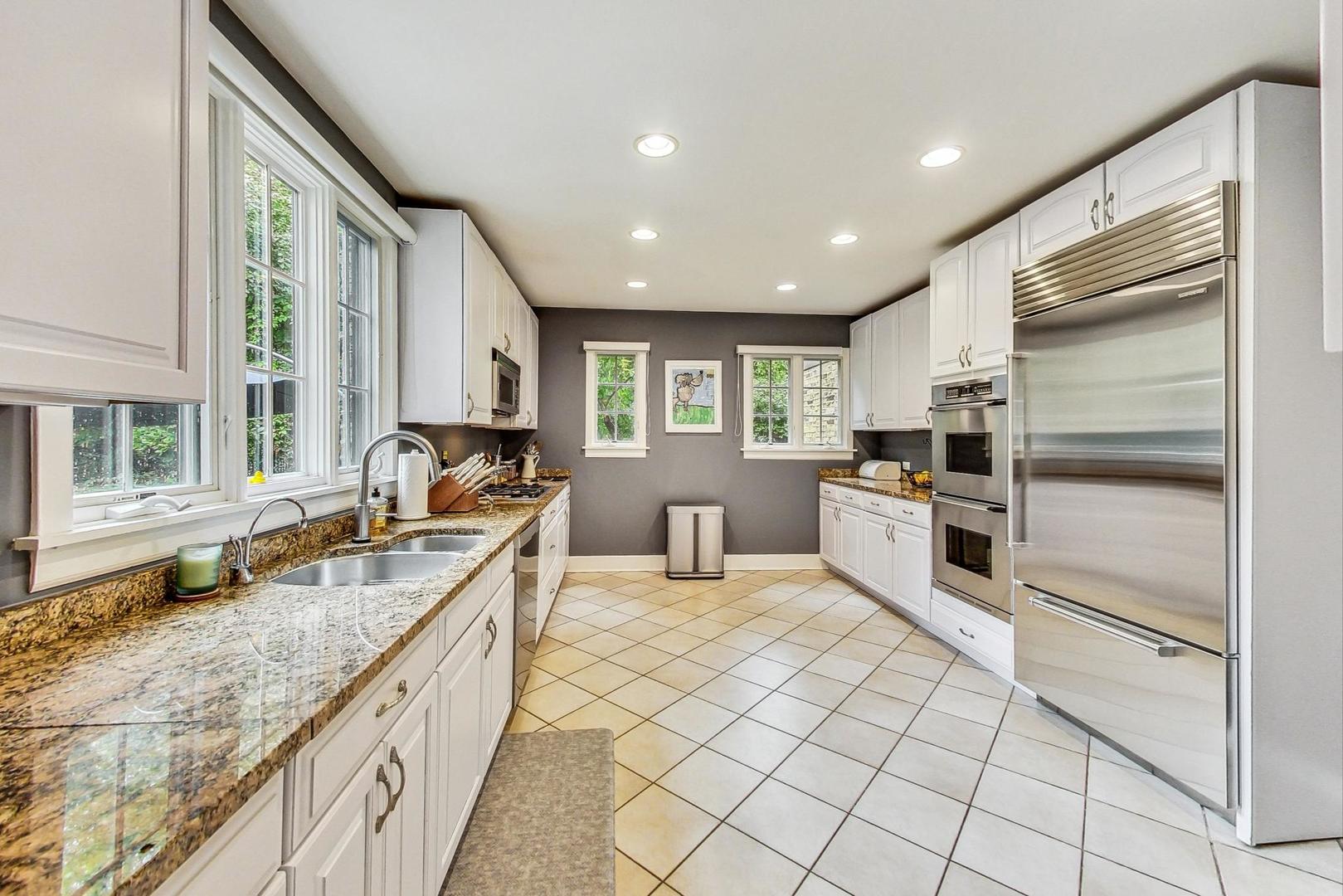 929 Valley Road Glencoe, IL 60022 - Photo 10 of 46 a kitchen with granite countertop stainless steel appliances a sink and counter space