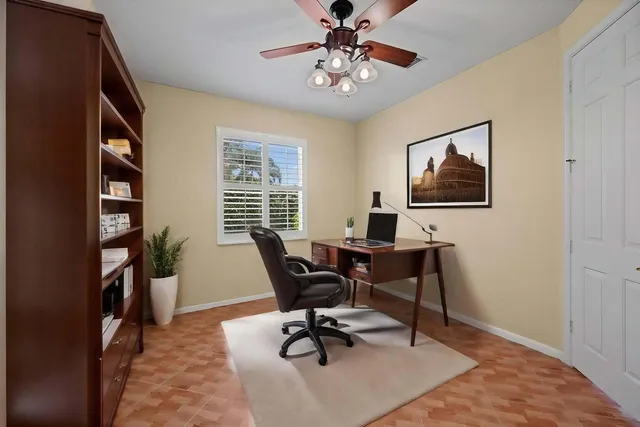 a view of a workspace with furniture and a window