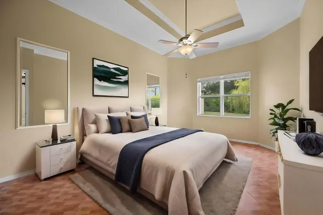 a bedroom with a bed a mirror and a flat screen tv