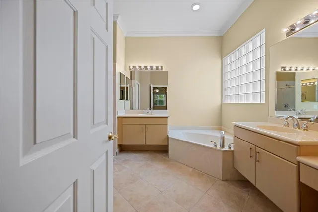 a bathroom with a tub sink and mirror