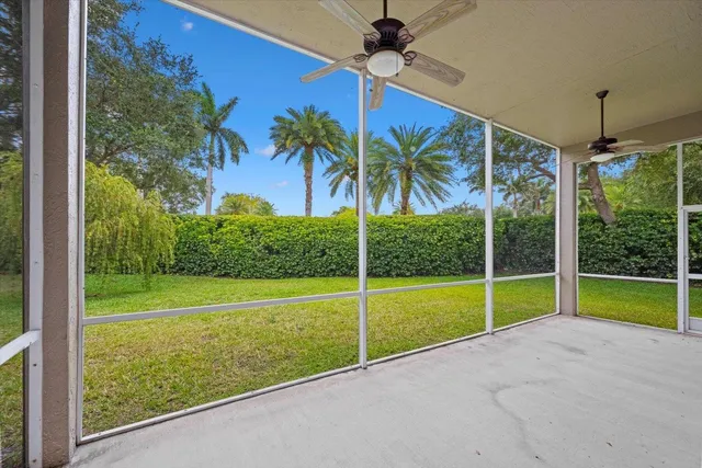 a view of an house with backyard and a floor to ceiling window