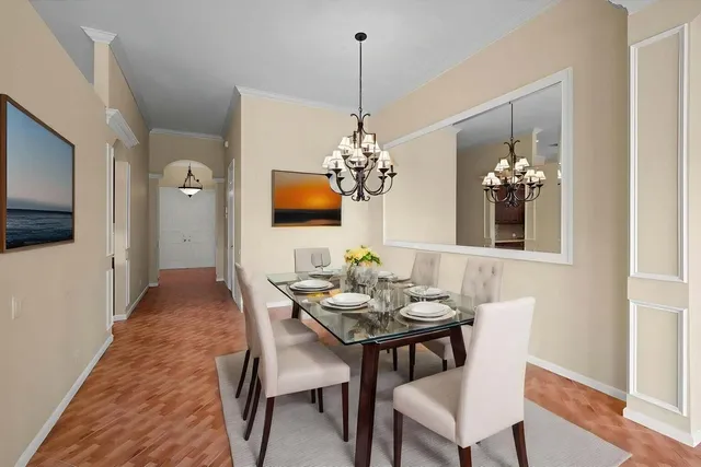 a dining room with furniture and chandelier