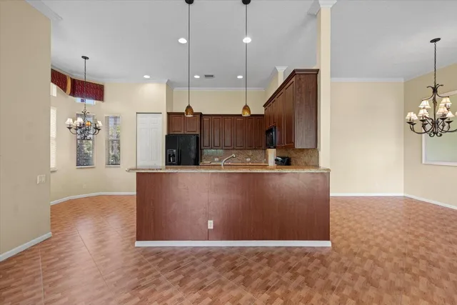 a view of kitchen with stainless steel appliances granite countertop wooden cabinets and a sink