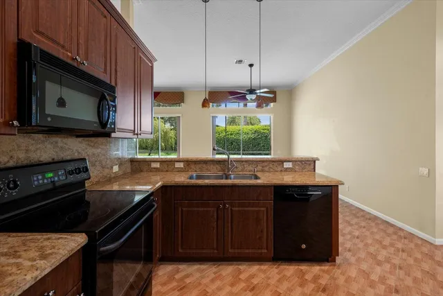 a kitchen with stainless steel appliances a sink stove and microwave