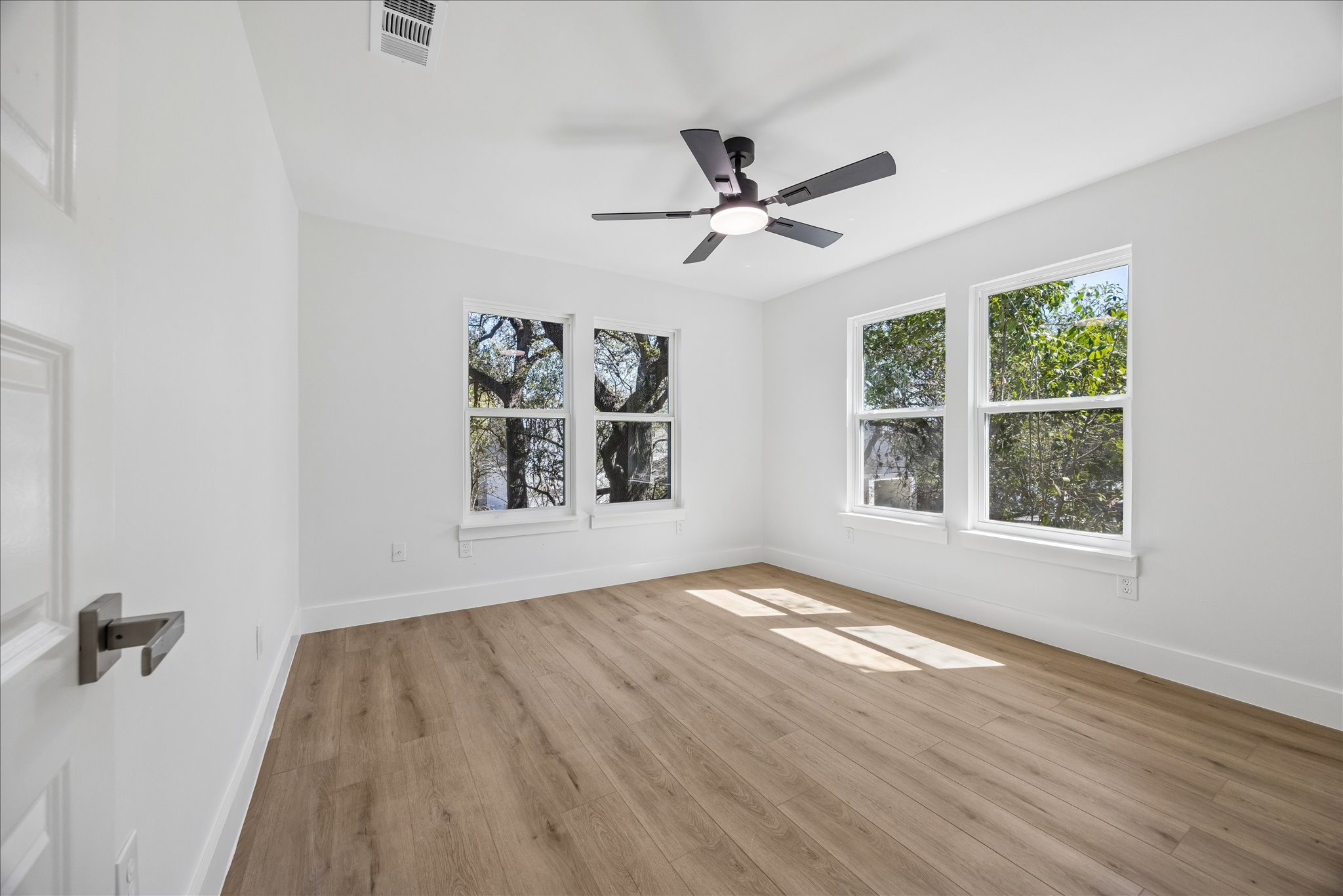808 West Elizabeth Street Austin, TX 78704 - Photo 14 of 20 Spare room with light wood-type flooring, plenty of natural light, and a ceiling fan