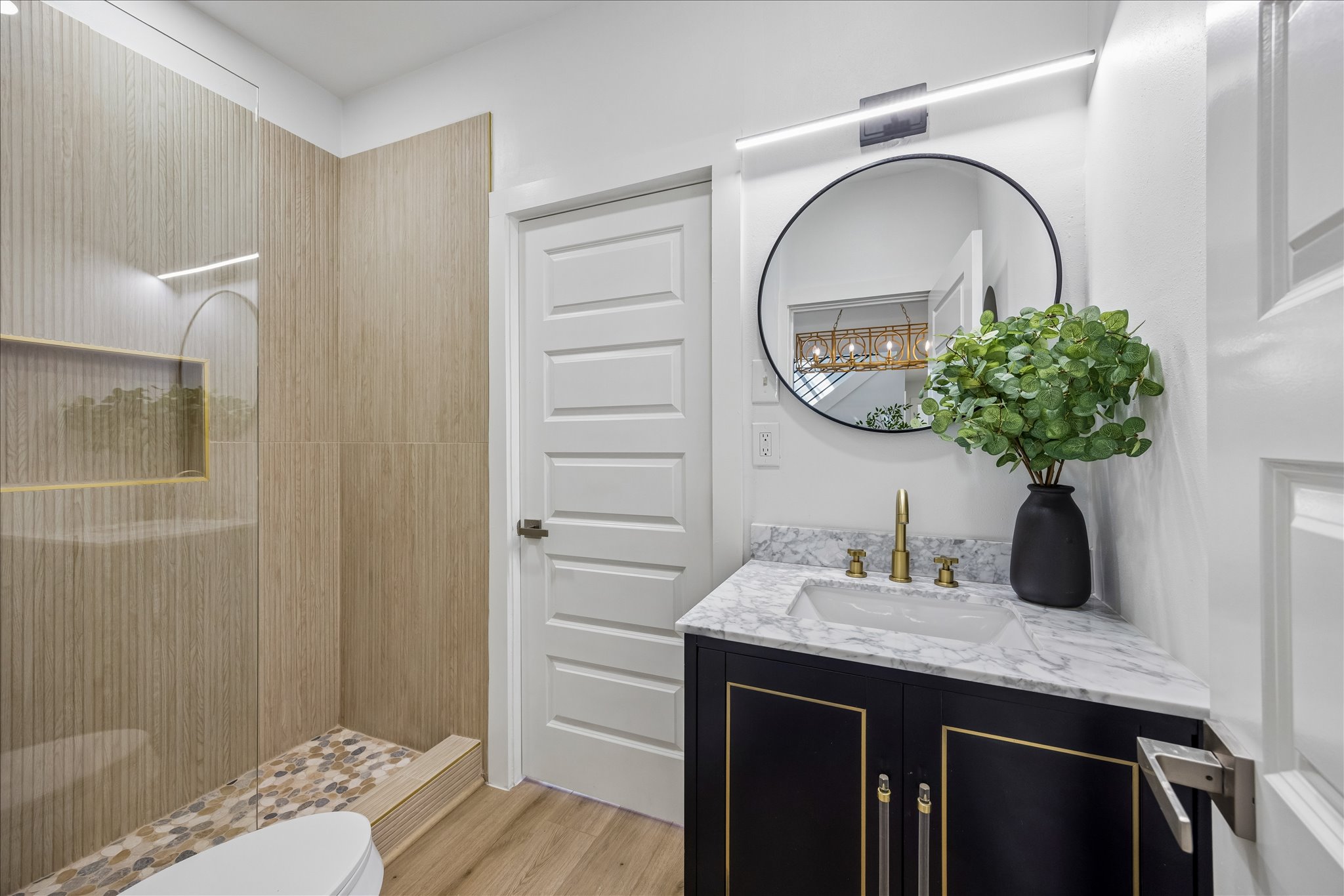 808 West Elizabeth Street Austin, TX 78704 - Photo 16 of 20 Bathroom with vanity, a shower stall, and light wood finished floors
