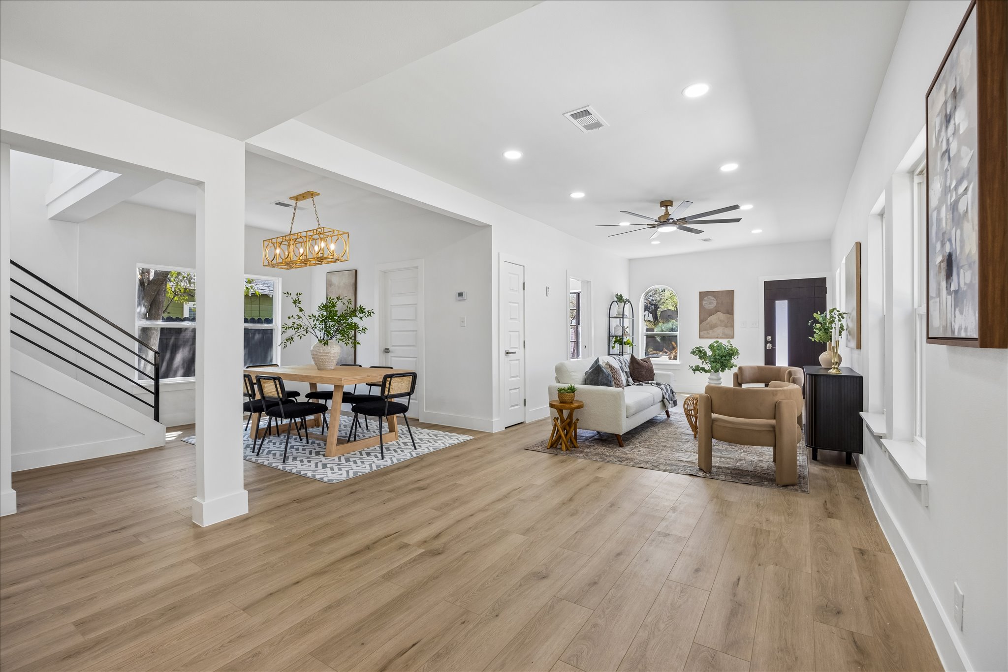 808 West Elizabeth Street Austin, TX 78704 - Photo 5 of 20 Living room featuring light wood-type flooring, suspended lighting, and a ceiling fan