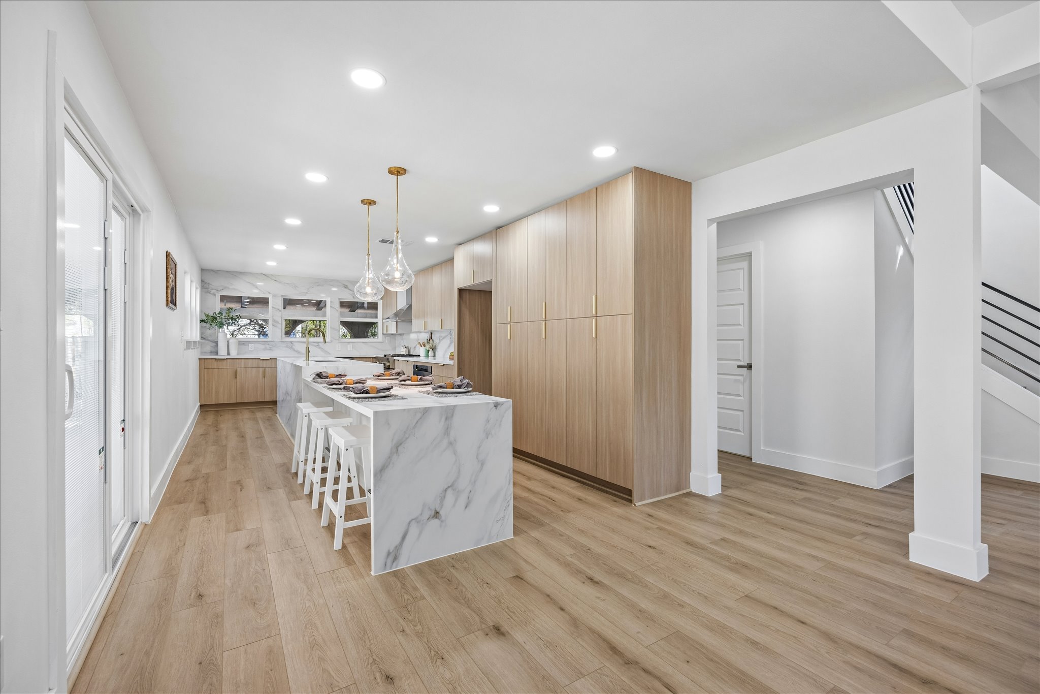 808 West Elizabeth Street Austin, TX 78704 - Photo 8 of 20 Kitchen featuring a kitchen breakfast bar, a center island, light wood finished floors, modern cabinets, and light wood finish cabinetry