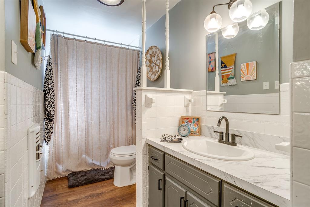 610 North Mesquite Hico, TX 76457 - Photo 24 of 34 a bathroom with a sink a toilet and a mirror