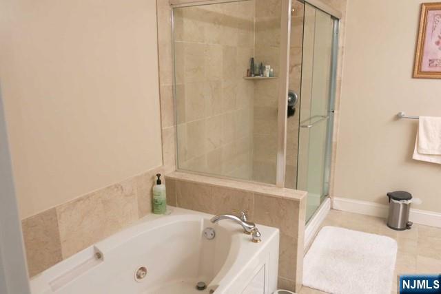 116 The Promenade, Unit 116 Edgewater, NJ 07020 - Photo 14 of 26 a bathroom with a tub and a sink