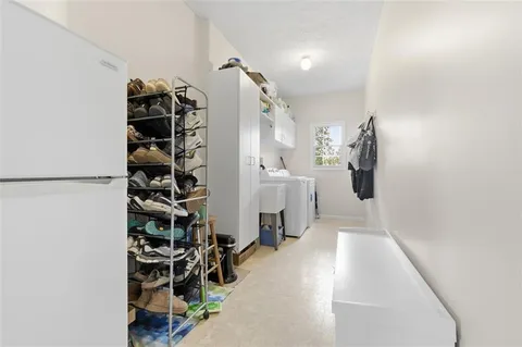 walk in closet with white walls