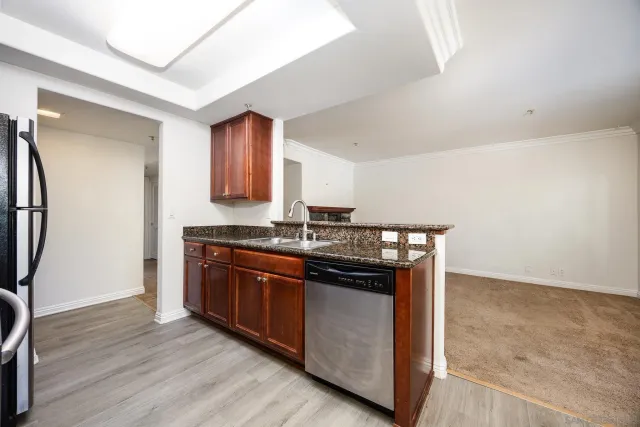 a kitchen with stainless steel appliances granite countertop a stove and a refrigerator
