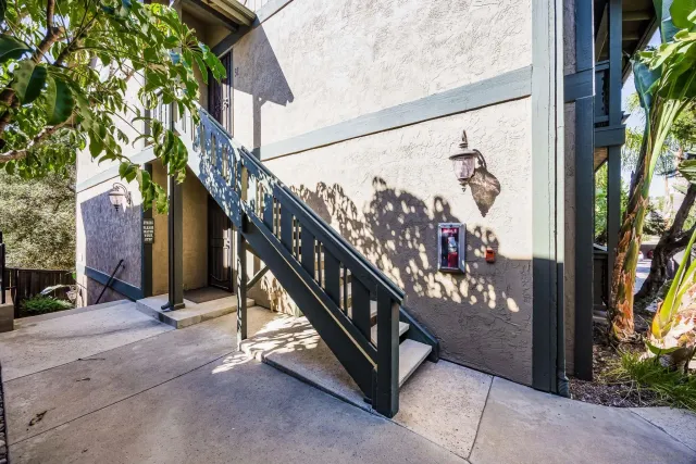 a view of staircase with railing and a potted plant