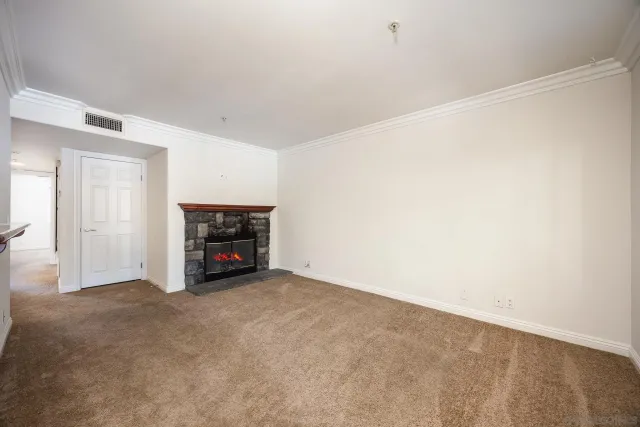 a view of an empty room with a fireplace