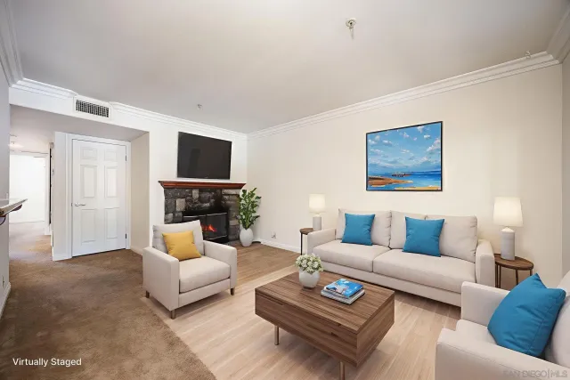 a living room with furniture a rug and a flat screen tv