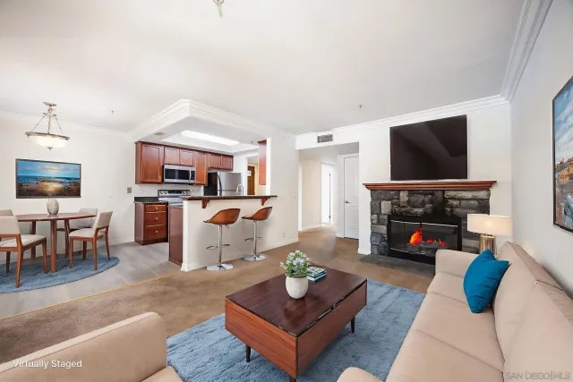 a living room with furniture a fireplace and a flat screen tv