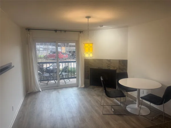 a dining room with furniture a chandelier and wooden floor