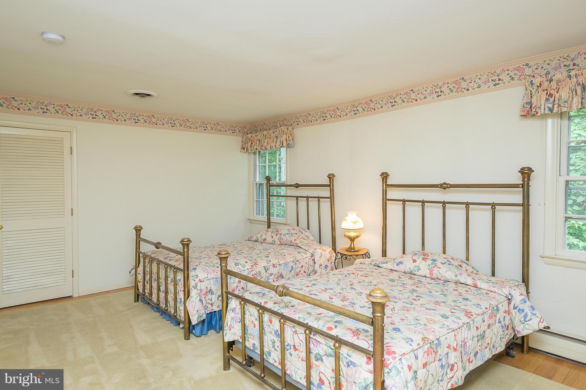 10836 Harding Road Laurel, MD 20723 - Photo 13 of 25 a bedroom with a bed a mirror and a window